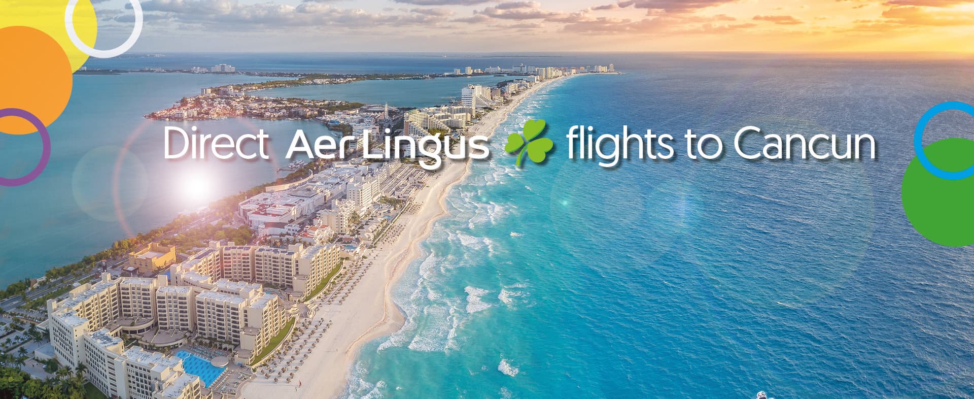 erial view of Cancun’s hotel zone with white sandy beaches, turquoise waters, and luxury resorts, promoting Aer Lingus direct flights to Cancun.