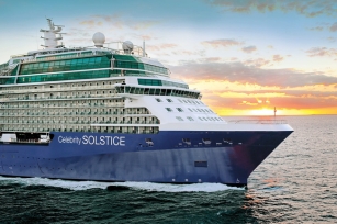 close up of the front of the Celebrity Solstice as the sun sets the ship cruises through the waters