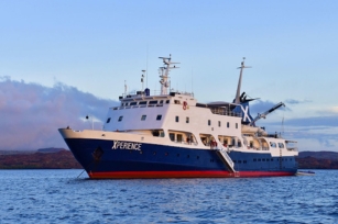 image featuring the Celebrity Xperience cruise ship featuring the clear blue waters and blue skies