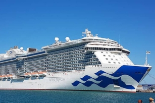 the cruise ship of the royal princess docked at a port featuring the clear blue skies
