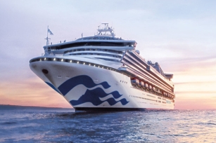 The image shows the Sapphire Princess cruise ship, during sunset with a calm sea and serene atmosphere.