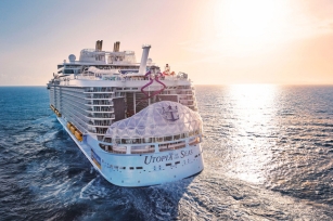 Utopia of the seas sailing through the sea as the sun shines against the cruise and waters